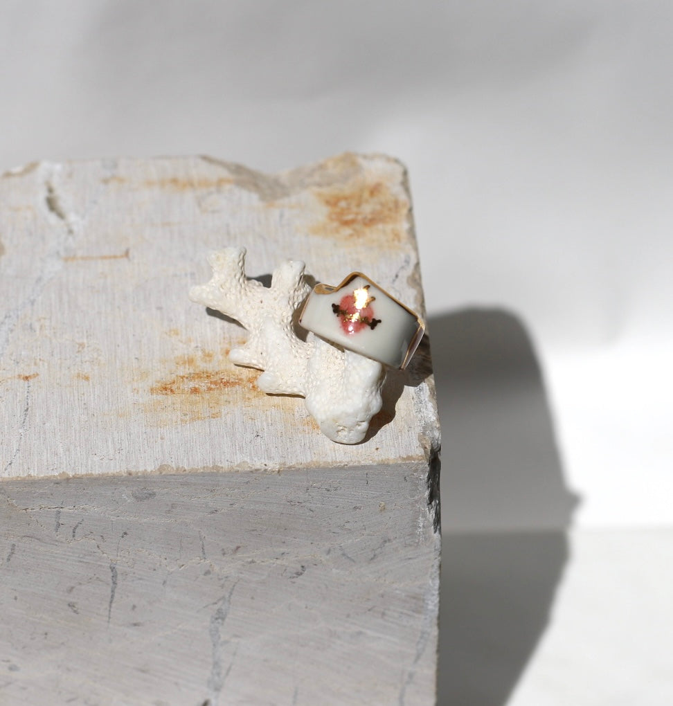Bague large en porcelaine blanche émaillée en taille 52FR avec un motif coeur ex-voto peint à la main avec des détails en noirs et à l'or liquide. Fait à la main à Lyon