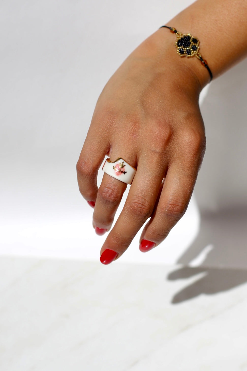 Bague large en porcelaine blanche émaillée en taille 52FR.  motif sacré coeur peint à la main avec des détails en noirs et or. Fait à la main à Lyon