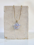 Collier en forme d'étoile ex-voto couleur bleu ciel avec inscription fuck peint à l'or liquide 