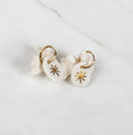 boucles d'oreilles pendantes en porcelaine blanche, ornés d'une étoile rayonnante peinte à l'or fin.