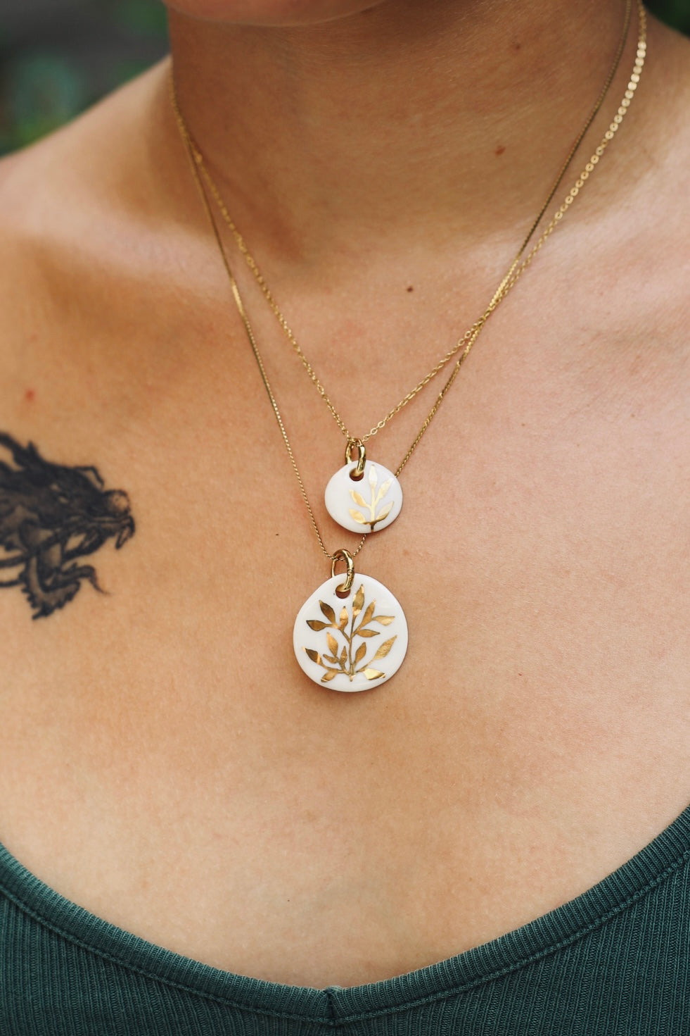collier en porcelaine blanc fait main avec un motif floral peint à l'or liquide 