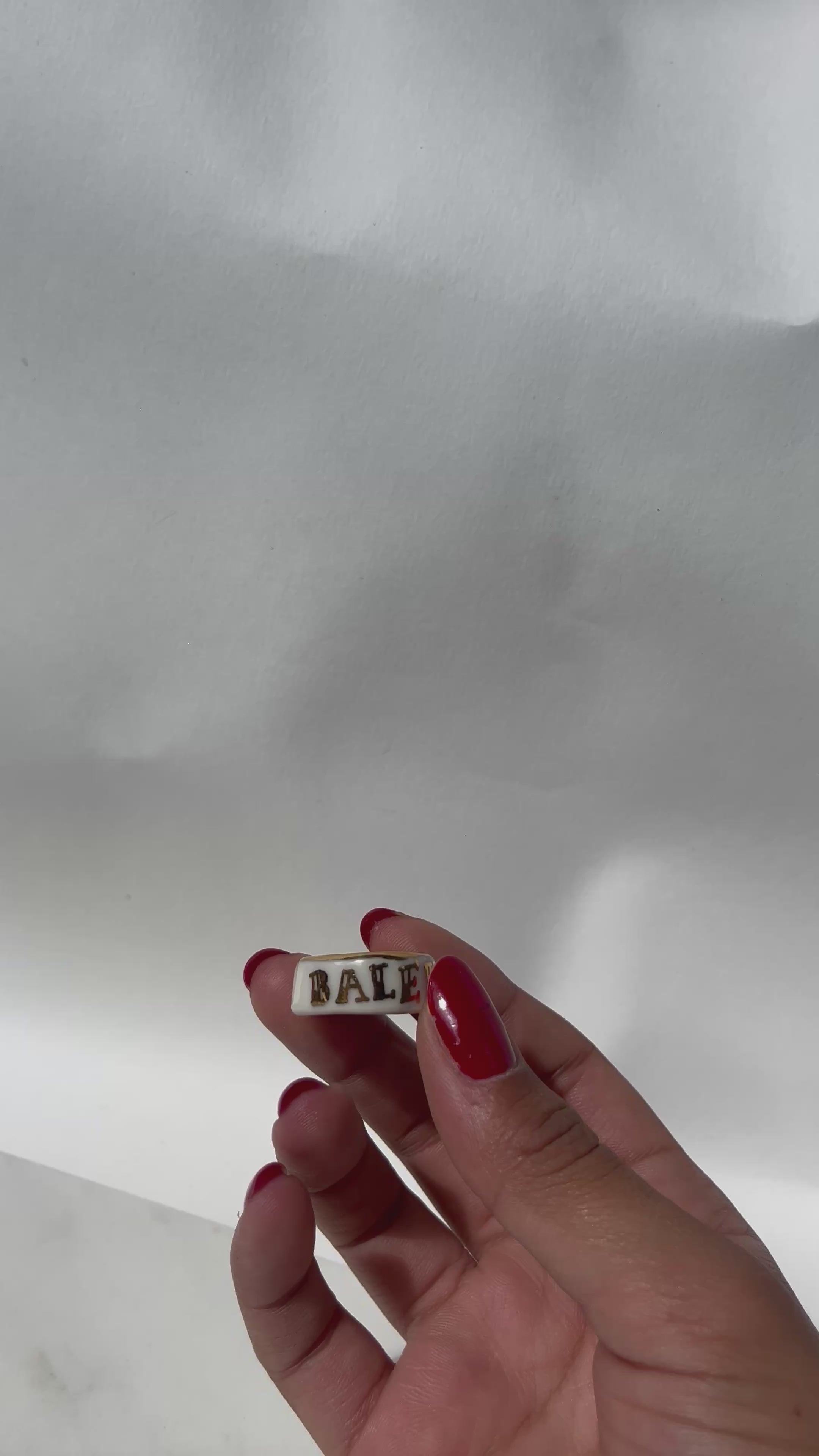 Bague en porcelaine blanc fait main avec des détails à l'or liquide et arborant le mot BALEK taille FR54